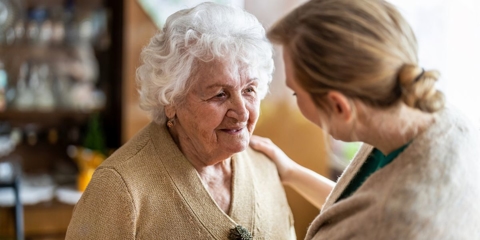 In-home caregiver assisting a senior with dementia.