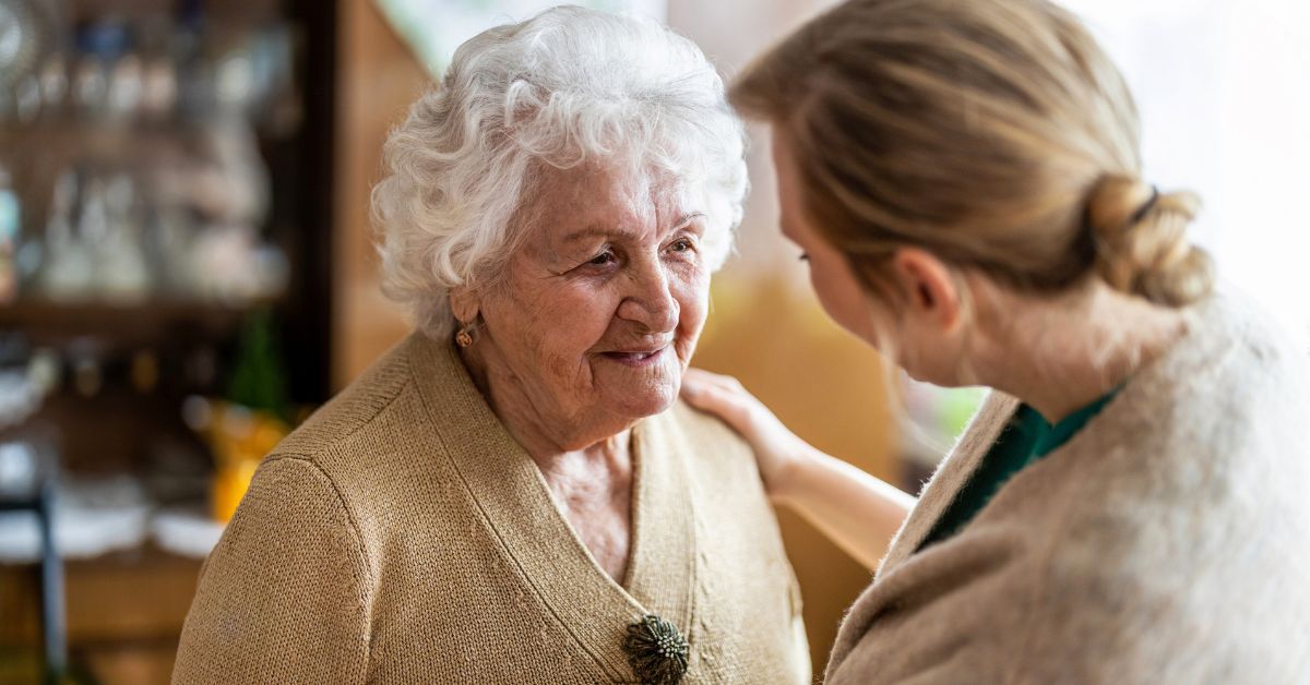In-home caregiver assisting a senior with dementia.