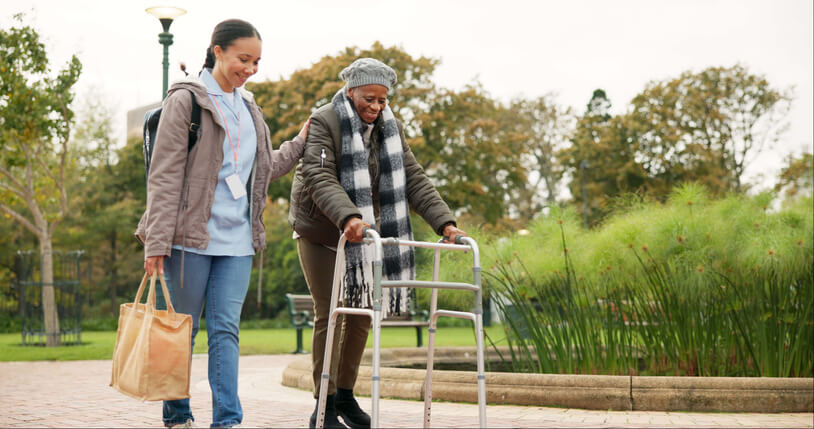 senior woman walking with attendant
