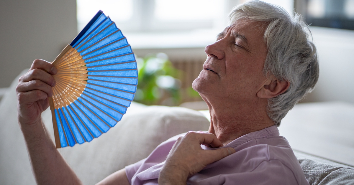 Old man using fan
